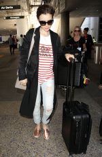 LILY COLLINS at Los Angeles International Airport 07/11/2015