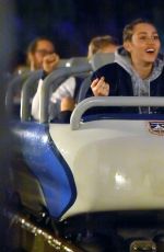 MILEY CYRUS and STELLA MAXWELL at Disneyland in Anaheim 07/14/2015
