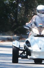 MILEY CYRUS Riding a Three-Wheeler in Bewerly Hills