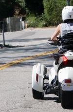MILEY CYRUS Riding a Three-Wheeler in Bewerly Hills