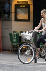 MIRA SORVINO Riding a Bike Out in Paris 07/04/2015