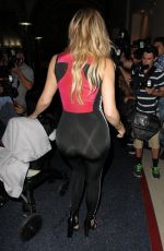 KHLOE KARDASHIAN in Tights at LAX Airport in Los Angeles 09/16/2015