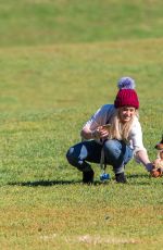 HILARY DUFF Playing with Dogs at a Park in New York 10/11/2015