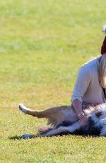 HILARY DUFF Playing with Dogs at a Park in New York 10/11/2015