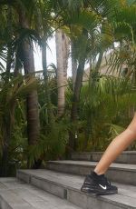 KHLOE KARDASHIAN Exercising in Swimsuit at a Pool in St. Barts