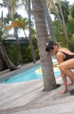 KHLOE KARDASHIAN Exercising in Swimsuit at a Pool in St. Barts
