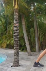 KHLOE KARDASHIAN Exercising in Swimsuit at a Pool in St. Barts