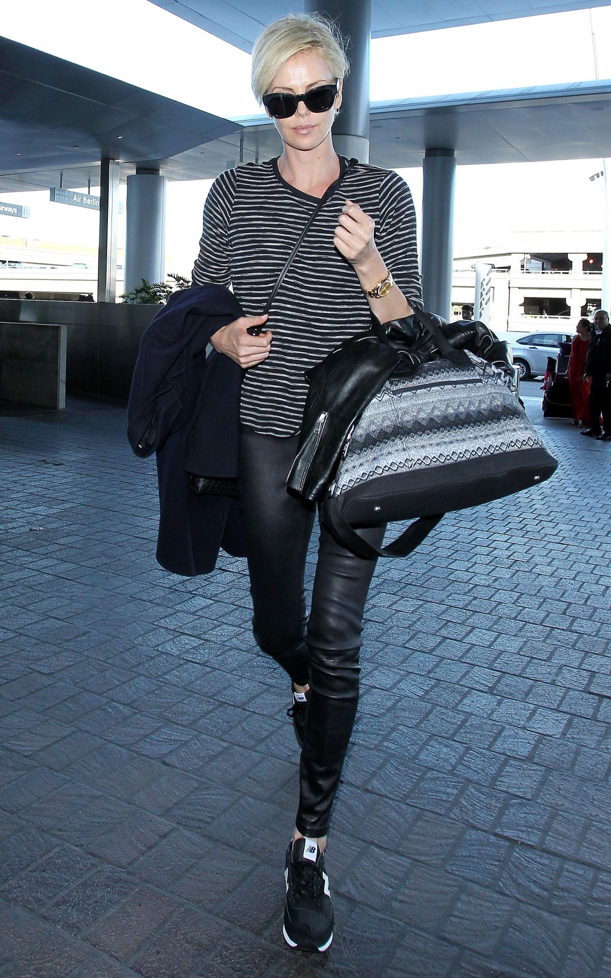 CHARLIZE THERON Arrives at Los Angeles International Airport 11/08/2015 ...