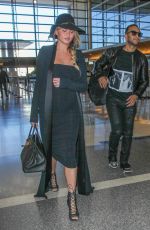 CHRISSY TEIGEN at Los Angeles International Airport 12/25/2015