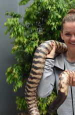 AGNIESZAK RADWANSKA Holding a Python Snake in Melbourne 01/21/2016