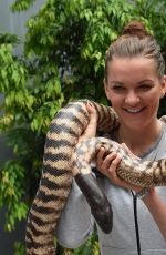 AGNIESZAK RADWANSKA Holding a Python Snake in Melbourne 01/21/2016