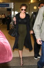 Pregnant CHRISSY TEIGEN at LAX Airport in Los Angeles 01/01/2016