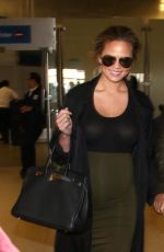 Pregnant CHRISSY TEIGEN at LAX Airport in Los Angeles 01/01/2016