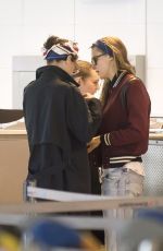 CARA DELEVINGNE and ANNIE CLARK at Charles De Gaulle Airport in Paris 02/20/2016