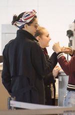 CARA DELEVINGNE and ANNIE CLARK at Charles De Gaulle Airport in Paris 02/20/2016