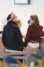 CARA DELEVINGNE and ANNIE CLARK at Charles De Gaulle Airport in Paris 02/20/2016