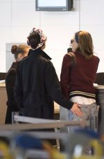 CARA DELEVINGNE and ANNIE CLARK at Charles De Gaulle Airport in Paris 02/20/2016