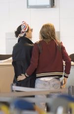 CARA DELEVINGNE and ANNIE CLARK at Charles De Gaulle Airport in Paris 02/20/2016
