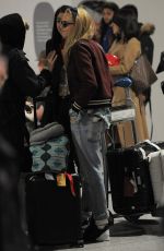 CARA DELEVINGNE and ANNIE CLARK at Charles-De-Gaulle Airport in Paris 02/28/2016