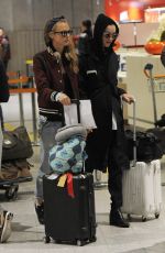 CARA DELEVINGNE and ANNIE CLARK at Charles-De-Gaulle Airport in Paris 02/28/2016