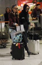 CARA DELEVINGNE and ANNIE CLARK at Charles-De-Gaulle Airport in Paris 02/28/2016