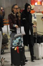 CARA DELEVINGNE and ANNIE CLARK at Charles-De-Gaulle Airport in Paris 02/28/2016