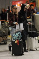 CARA DELEVINGNE and ANNIE CLARK at Charles-De-Gaulle Airport in Paris 02/28/2016