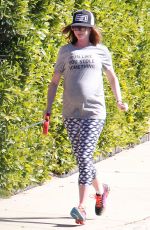 Pregnant ANNE HATHAWAY Walks Her Dog Out in Los Angeles 02/14/2016