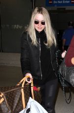 DAKOTA FANNING at LAX Airport in Los Angeles 03/09/2016