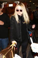 DAKOTA FANNING at LAX Airport in Los Angeles 03/09/2016