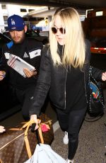 DAKOTA FANNING at LAX Airport in Los Angeles 03/09/2016