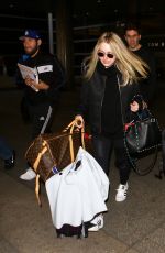 DAKOTA FANNING at LAX Airport in Los Angeles 03/09/2016