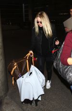 DAKOTA FANNING at LAX Airport in Los Angeles 03/09/2016