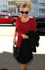 PAMELA ANDERSON Arrives at Los Angeles International Airport 03/24/2016