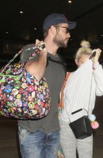 MILEY CYRUS and Liam Hemsworth at LAX Airport in Los Angeles 05/02/2016