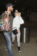 MILEY CYRUS and Liam Hemsworth at LAX Airport in Los Angeles 05/02/2016