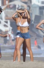 CHARLOTTE MCKINNEY in Bikini Top at a Beach Party in Malibu 07/02/2016