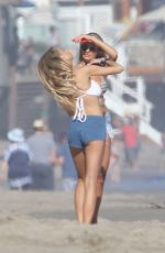 CHARLOTTE MCKINNEY in Bikini Top at a Beach Party in Malibu 07/02/2016