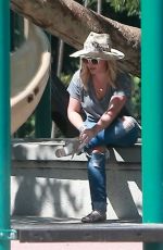HILARY DUFF in Ripped Jeans at a Park in New York 07/25/2016