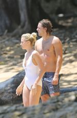 MARGOT ROBBIE in Swimsuit Surfing in Hawaii 07/19/2016