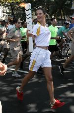 ALESSANDRA AMBROSIO Runs with Olympic Flame Through Rio De Janeiro 08/05/2016