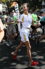 ALESSANDRA AMBROSIO Runs with Olympic Flame Through Rio De Janeiro 08/05/2016