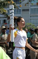 ALESSANDRA AMBROSIO Runs with Olympic Flame Through Rio De Janeiro 08/05/2016