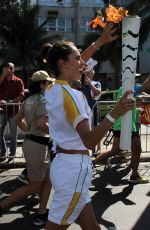 ALESSANDRA AMBROSIO Runs with Olympic Flame Through Rio De Janeiro 08/05/2016