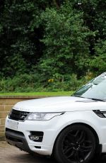 CHLOE KHAN Washing Her Range Rover in a Bikini Top and Cut Off in London 09/20/2016