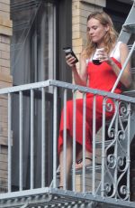 DIANE KRUGER Sipped Wine on Her Fire Escape in New York 09/06/2016