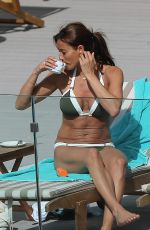 MELANIE SYKES in Bikini at Her Hotel Pool in Ibiza 10/17/2016