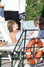PENNY LANCASTER in Bikini at a Pool in Italy 09/19/2016