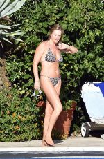 PENNY LANCASTER in Bikini at a Pool in Italy 09/19/2016