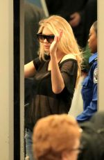 CHARLOTTE MCKINNEY in Ripped Jeans at LAX Airport 12/14/2016